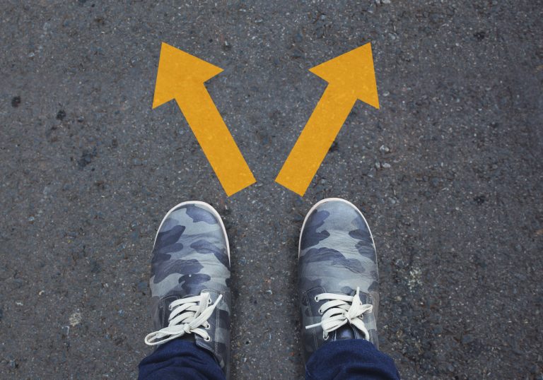 Pair,Of,Shoes,Standing,On,A,Tarmac,Road,With,Two